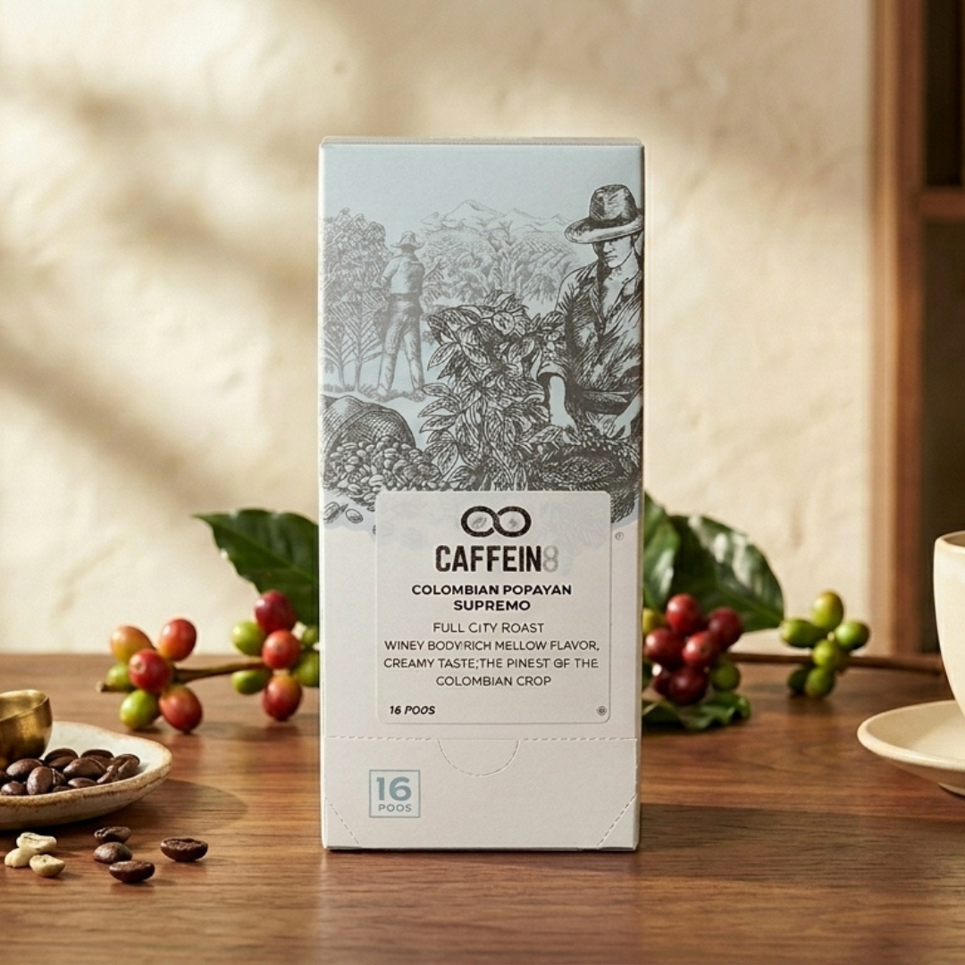 CAFFEIN8 Colombian Popayan Supremo 16-pod box styled on wood table with fresh coffee cherries and beans