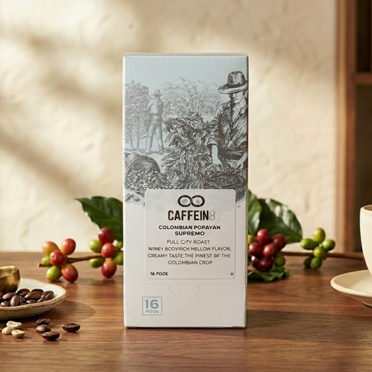 CAFFEIN8 Colombian Popayan Supremo 16-pod box styled on wood table with fresh coffee cherries and beans