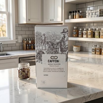 CAFFEIN8 Donut Shoppe coffee pods box on a marble kitchen counter with a jar of coffee beans