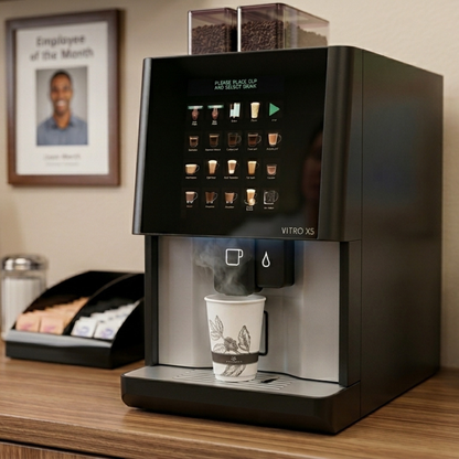 CAFFEIN8 Emerald 12oz hot cup being filled at a Vitro X5 office coffee machine in a workplace breakroom