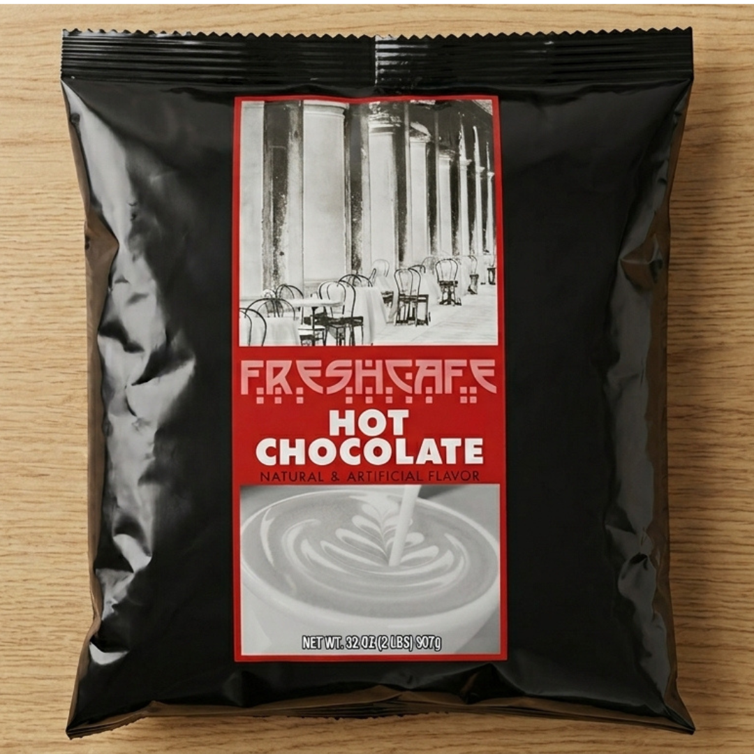 CAFFEIN8 Hot Chocolate Mix Powder 2 lb bag laying flat on a light wood surface, black pouch with red label for office coffee station use