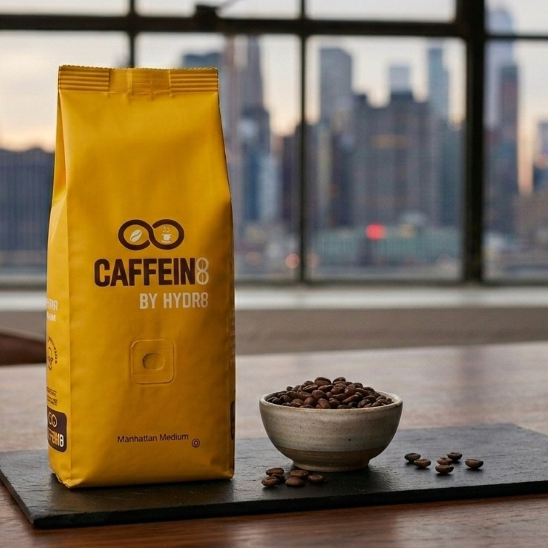 CAFFEIN8 Manhattan Medium Roast coffee bag with beans and NYC skyline backdrop