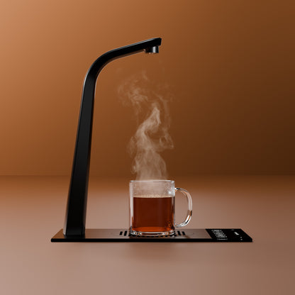 HYDR8 countertop tap dispensing steaming hot water into a glass mug of tea