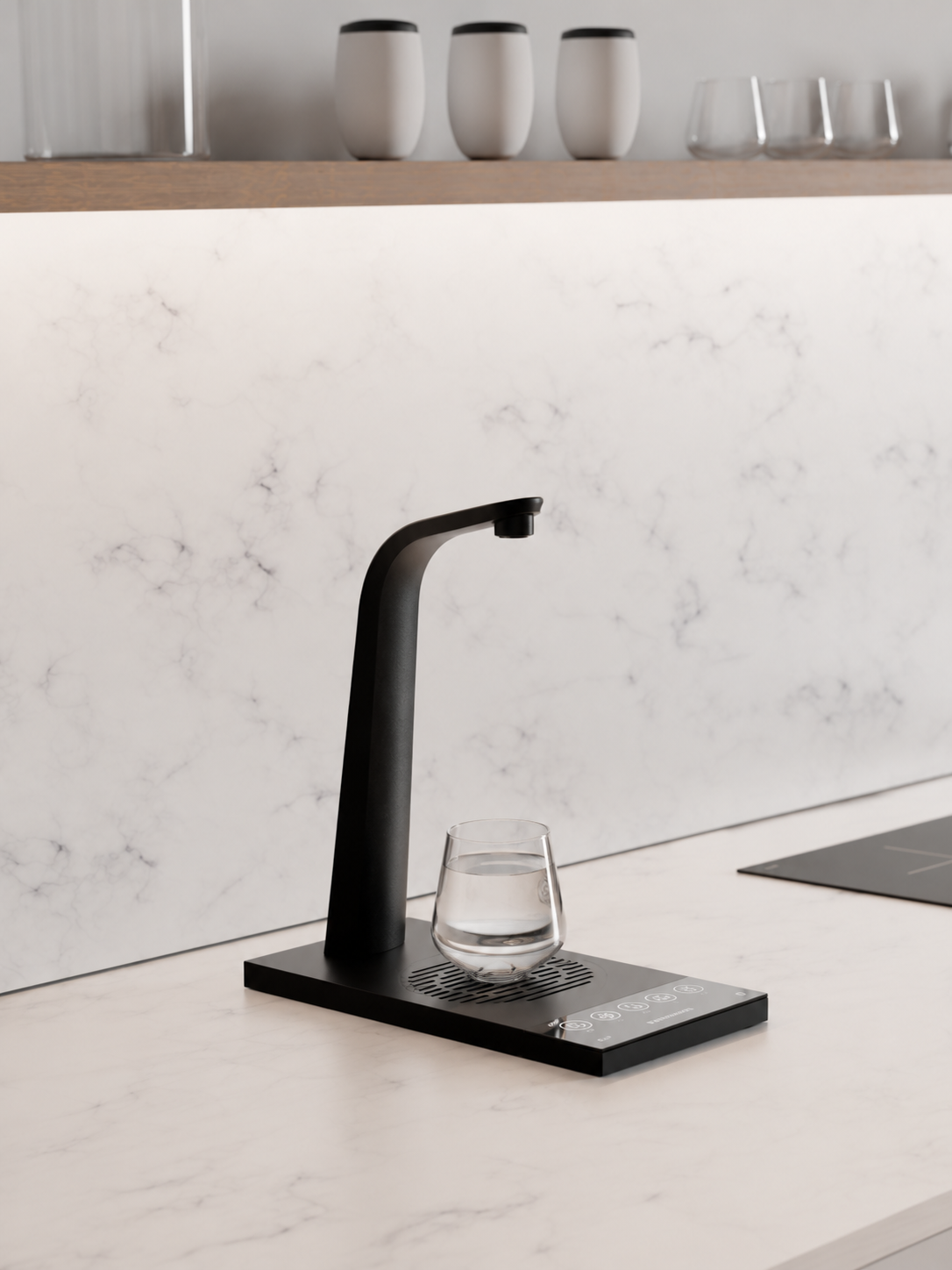 Black HYDR8 countertop water tap dispensing filtered still water into a glass on a white marble counter