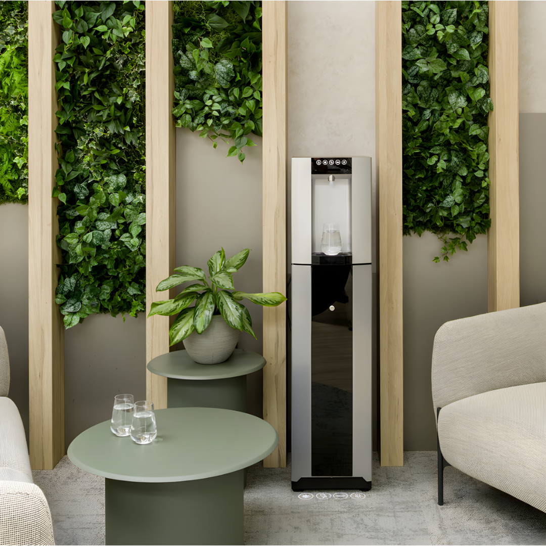 HYDR8 premium freestanding water dispenser in an office lounge with living green walls and seating